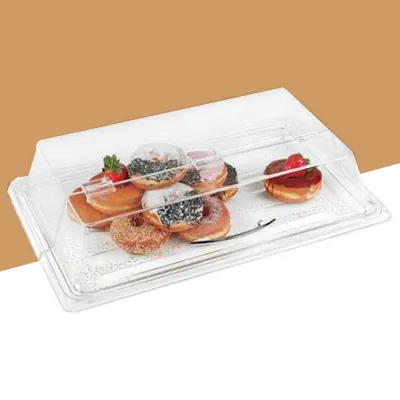 Bakery display tray with a clear lid holding decorated doughnuts