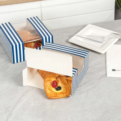 Blue striped bakery box holding a filled pastry with a paper band