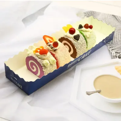 Long printed bakery display tray holding a decorated Swiss roll