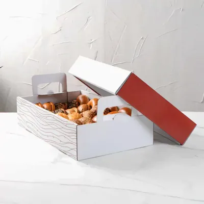 White catering tray with a red lid holding baked pastries