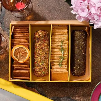 Kraft divided tray holding crackers, breadsticks and pâté with a dried orange garnish