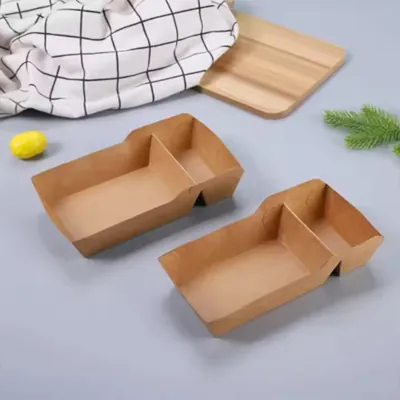 Two kraft chip and dip trays with a wooden lid on a plain surface