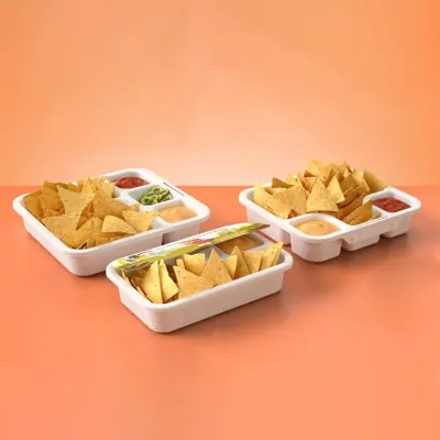 White chip and dip trays holding tortilla chips with salsa and guacamole