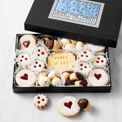 Black cookie box with a lid holding decorated shortbread biscuits