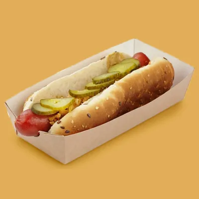 Kraft corn dog tray holding a hot dog with pickles on an amber background