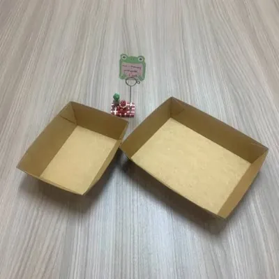 Two shallow corrugated appetizer trays on a wooden surface