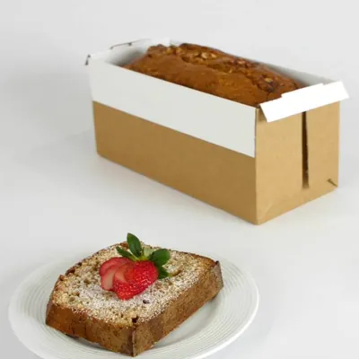 Corrugated bread tray with a white top edge holding a baked loaf