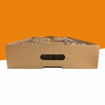 Corrugated bread tray with a die-cut hand hole holding a seeded loaf