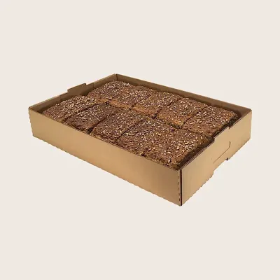 Shallow corrugated tray holding a sliced tray bake