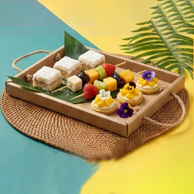 Kraft dessert platter with rope handles holding petits fours and fruit tartlets