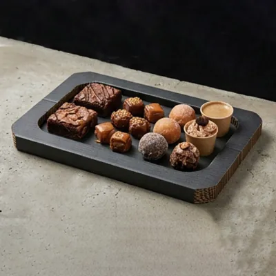 Matt black corrugated dessert platter holding brownies and small bakes