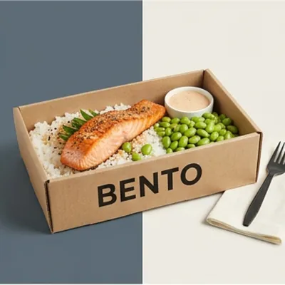 Corrugated bento-style lunch tray holding salmon, rice and edamame