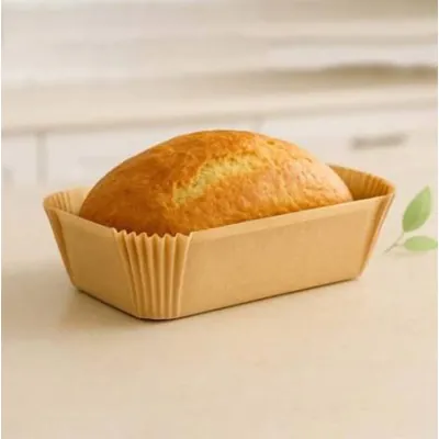 Golden loaf cake baked in a kraft pleated paper liner