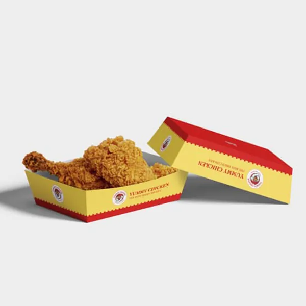 Printed catering trays in red and yellow holding fried chicken portions