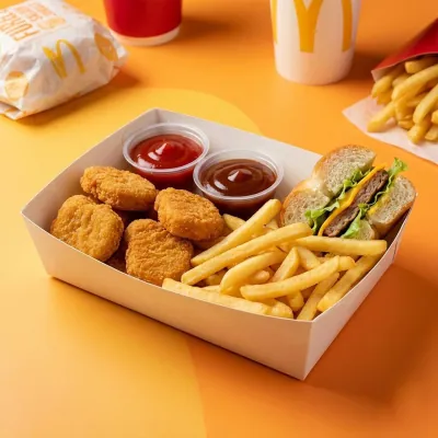 Kraft catering tray printed and filled with nuggets, fries, a burger and dip pots