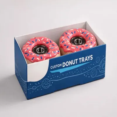 Blue printed donut box holding two decorated doughnuts
