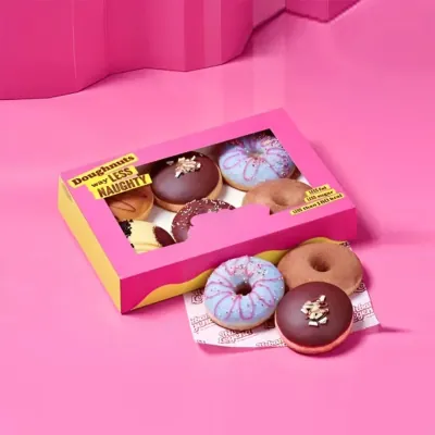 Bright pink and yellow donut box holding assorted iced doughnuts