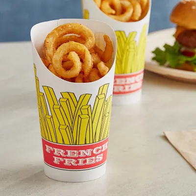 Printed fry cups holding curly fries beside a burger