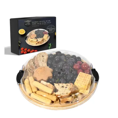 Round domed grazing board holding cheese, crackers, berries and nuts