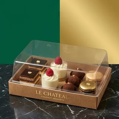 Kraft dessert tray with a clear dome holding chocolate desserts and tartlets