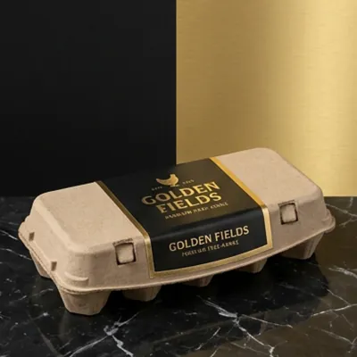 Moulded fibre egg carton with a dark printed band on a marble surface