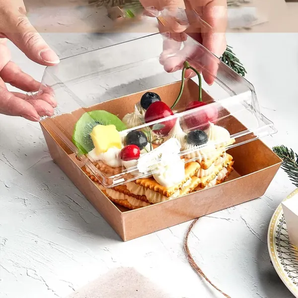 Mini charcuterie tray with a clear lid holding fruit, cheese and crackers