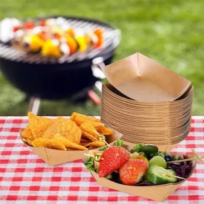 Stack of kraft mini charcuterie trays at an outdoor picnic table