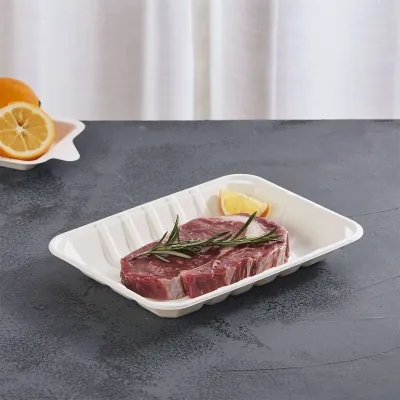 Moulded fibre meat tray holding a raw steak with rosemary