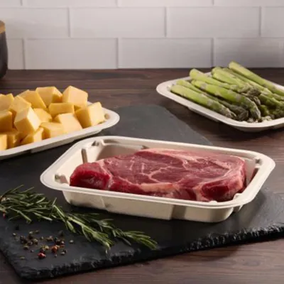 Moulded fibre trays holding beef, asparagus and cheese on a kitchen counter