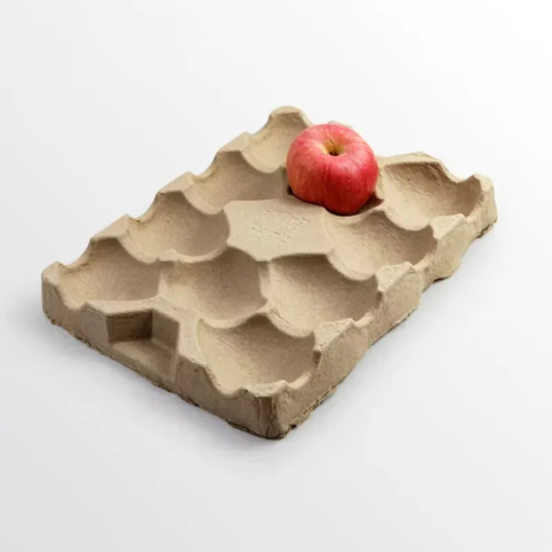 Angled view of a kraft moulded fibre produce tray with an apple in a pocket